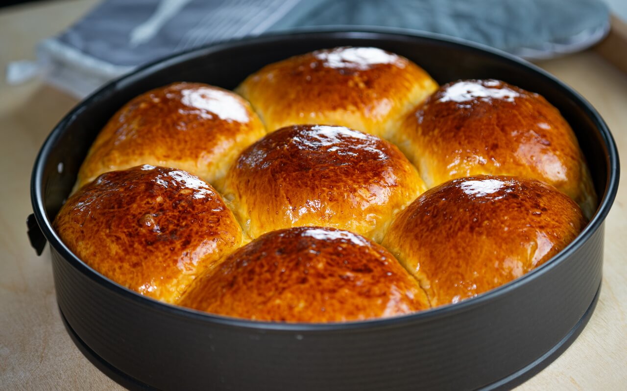Soft And Fluffy Milk Bread Rolls After Baking But Still In Baking Pan